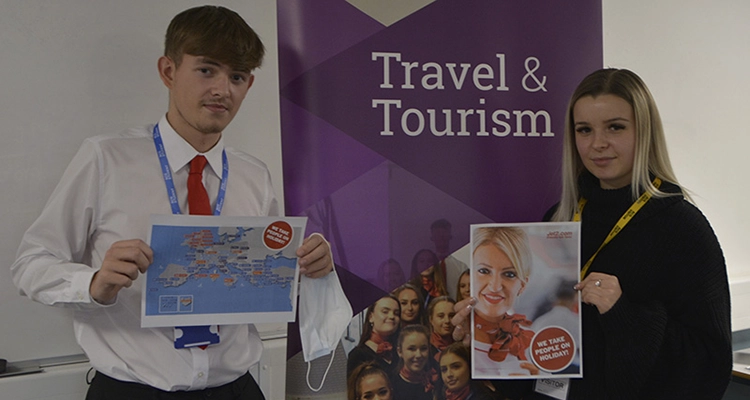 Travel & Tourism students holding up pages from their Jet2 welcome pack